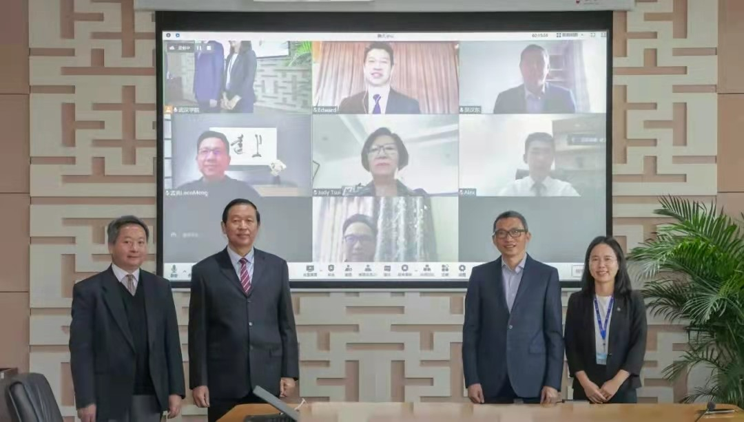 A group of people standing in front of a large screen Description automatically generated with medium confidence