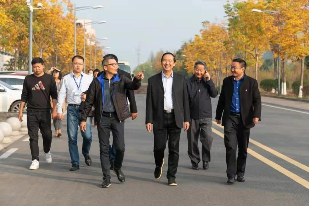 A group of men walking down a street Description automatically generated with medium confidence